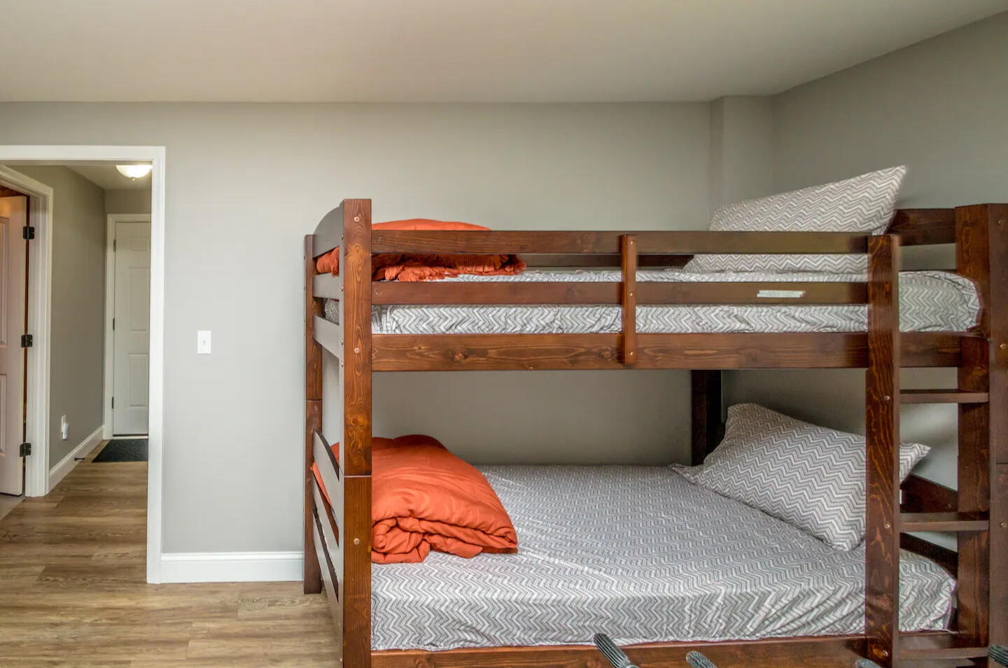 Cozy twin bedroom with new mattresses, pillows, mattress covers and bedding. Flat screen tv on wall. Closet across hall with dresser inside and room for hanging clothes. Plenty of wall hooks and storage chest for your clothes. Window AC in Summer.