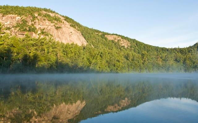 Cathedral Ledge is a prominent granite cliff located in North Conway, New Hampshire, renowned for its stunning views and popular rock climbing routes.